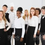 Portrait Of Confident Restaurant Staff Standing Against White Background