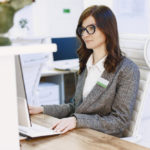 woman-administrator-on-the-visitor-reception-friendly-young-woman-in-suit